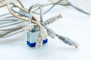 bundle of network wires blocked with metal padlock on white background