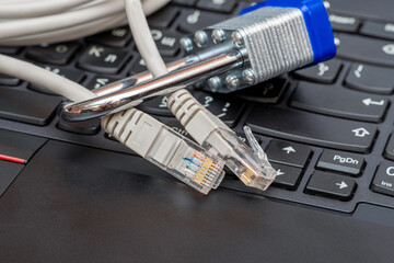 network wires blocked with a metal lock on the background of the keyboard