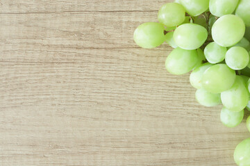 Bunch of grapes close-up on a wooden background, place for text, design, decorative, dessert