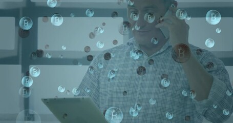Poster - Multiple bitcoin symbols floating against man with digital tablet talking on smartphone