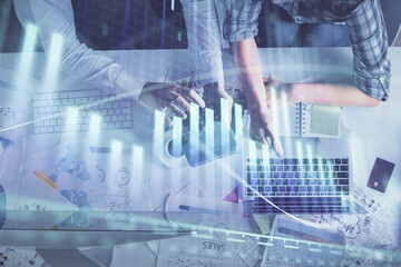 Poster - Multi exposure of man and woman working together and forex graph hologram drawing. Financial analysis concept. Computer background. Top View.