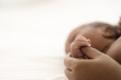 © Mongkolchon - african american infant baby lying on bed