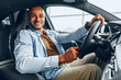 © fotofabrika - Portrait of a handsome happy African American man sitting in his newly bought car