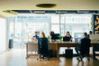 © Lumina/Stocksy - Businesswomen and Businessmen Sitting at an Open Space Office