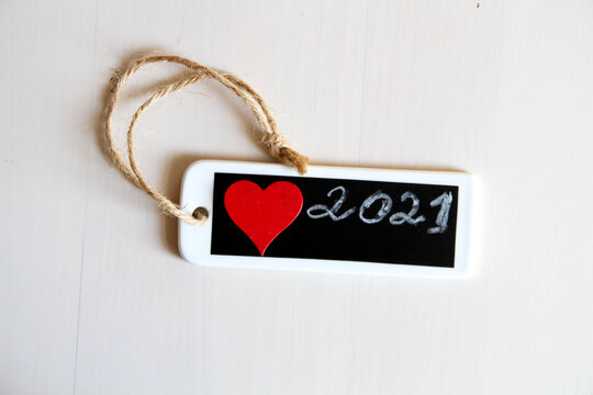 Design conception. Hand writing 2021 new year with chalk in black board. Red Heart. Love. Healthy. 