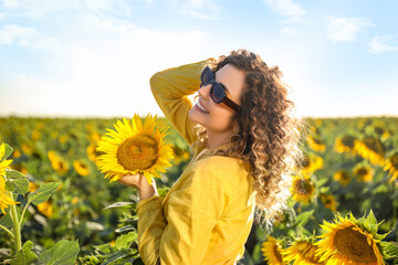 Sticker - Beautiful young woman in sunflower field