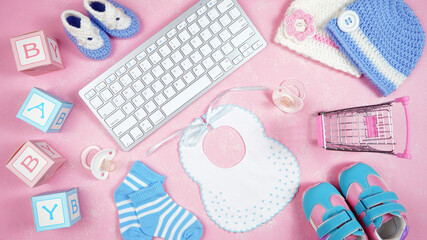Wall Mural - Baby nursery clothing mom bloggers desktop workspace with pink and blue accessories and shopping cart on pink textured background. Top view blog hero header creative composition flat lay.