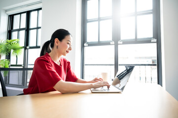 Work at home, Video conference, Online meeting video call, Portrait of beautiful young asian woman looking at computer screen watching webinar and working on laptop in workplace