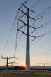 © Luis Cerdeira/Stocksy - Electricity transmission line at dusk