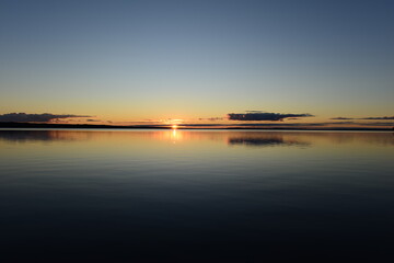 Wall Mural - Tranquil scene sunset on the lake  brightly glowing sunbeam glides on calm water