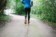 © Ivo de Bruijn/Stocksy - Man running on a gravel road wet with rain, surrounded by trees