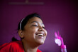 © Dream Lover/Stocksy - Teenage girl enjoying the air delivered by a small tiny fan and making fun