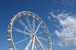 © Helen Davies - White ferris wheel against a blue sky background