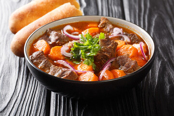 Poster - Bo kho is a delicious spicy beef stew dish, that is popular in Vietnam close-up in a bowl on the table. Horizontal
