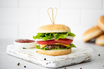 homemade hamburger with ketchup ans spices on white board