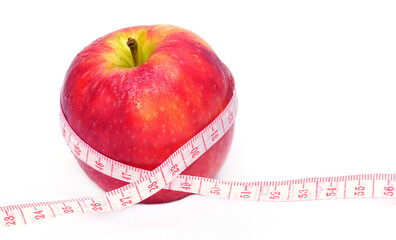 Loss weight, slim body, healthy diet concept. Measure tape and fresh fruit apple close up on white background with copy space for text.