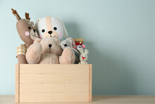 Crate With Different Toys On Wooden Table. Space For Text