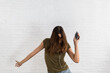 © Good Vibrations Images/Stocksy - Woman dancing holding a cell phone
