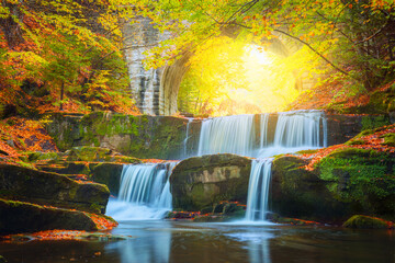 Wall Mural - autumn landscape - river waterfall in colorful autumn forest with old bridge