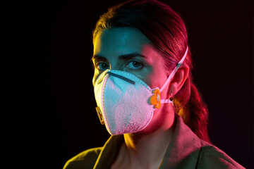Poster - health, safety and pandemic concept - young woman wearing protective mask or respirator over black background