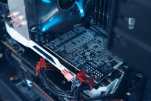 Inside A High Performance Computer. Motherboard And CPU Cooling Fans Illuminated By Internal LEDs Inside A Server Computer. Concept Of Computer Repair And Modern Technology