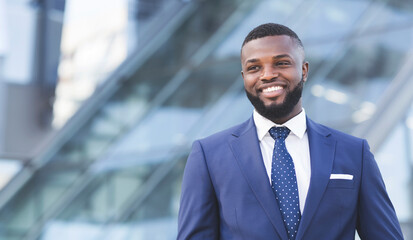 Happy African Entrepreneur Standing In Urban Area In City