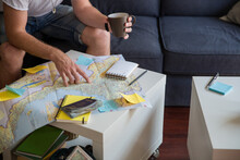 Man Planing His Vacation In His Living Room Alone
