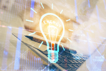 Poster - Computer on desktop in office with bulb icon hologram. Double exposure. Concept of idea.