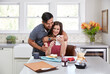 © Trinette Reed/Stocksy - Young couple having breakfast together at home in the morning while looking at mobile phone