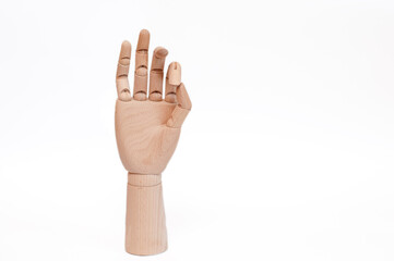 wooden hand shows okey on a white background.