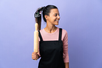 Wall Mural - Young woman in chef uniform looking side