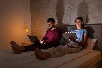 Wall Mural - Couple working late in bed