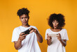 © Drobot Dean - Photo of african american people playing online game on cellphone