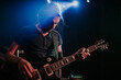 © BORIS JOVANOVIC/Stocksy - Young man playing an electric guitar on stage