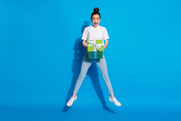 Sticker - Full size photo of astonished positive girl jump hold big green gift box get receive 14-february 8-march anniversary wear good look white t-shirt isolated bright shine color background