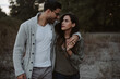 © Jess Craven/Stocksy - Young attractive couple hugging and laughing on the beach at dusk