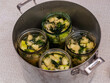 jars of vegetables in a large aluminum pan. pasteurization of canned vegetables