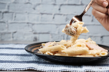  homemade cooked pasta in a plate on table .