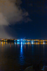 Wall Mural - Night photo of Reykjavik city beach. Waterfront lights