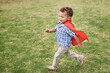 © Per Swantesson/Stocksy - Confident toddler playing super hero in a park