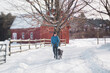 © LÔøΩÔøΩa Jones/Stocksy - teen running in the snow with her dog