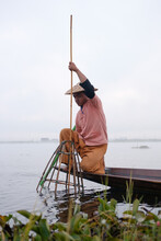Traditional Shan Fisherman Using Conical Net To Cat Fish On Inle Lake, Myanmar