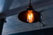 © Bill - Vintage hanging lamp with light bulb over blurry background