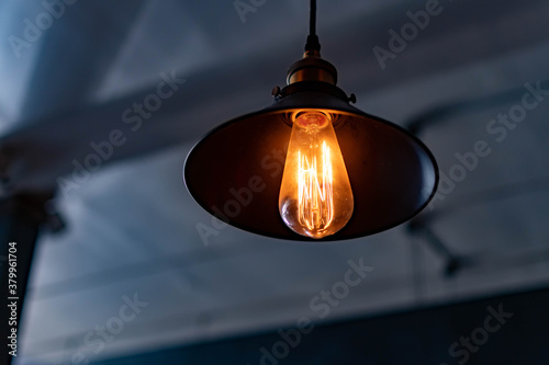 Cuadros en Lienzo Vintage hanging lamp with light bulb over blurry background