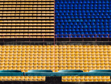 Empty Out Of Focus Blue And Yellow Seats On The Stadium