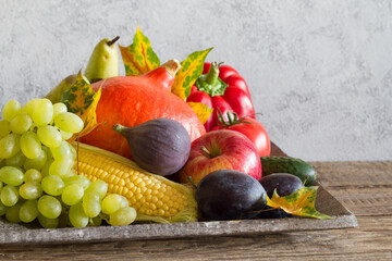 Wall Mural - Autumn fruits and vegetables on grey background