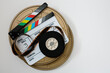 © kkgas/Stocksy - white clapperboard with 35mm film reel and film canisters over white background