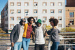 © MyMicrostock/Stocksy - Group of 4 black race friends in the city