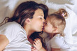 Mother kisses her daughter.