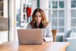 © Jakob Lagerstedt/Stocksy - Beautiful woman working on a computer at home